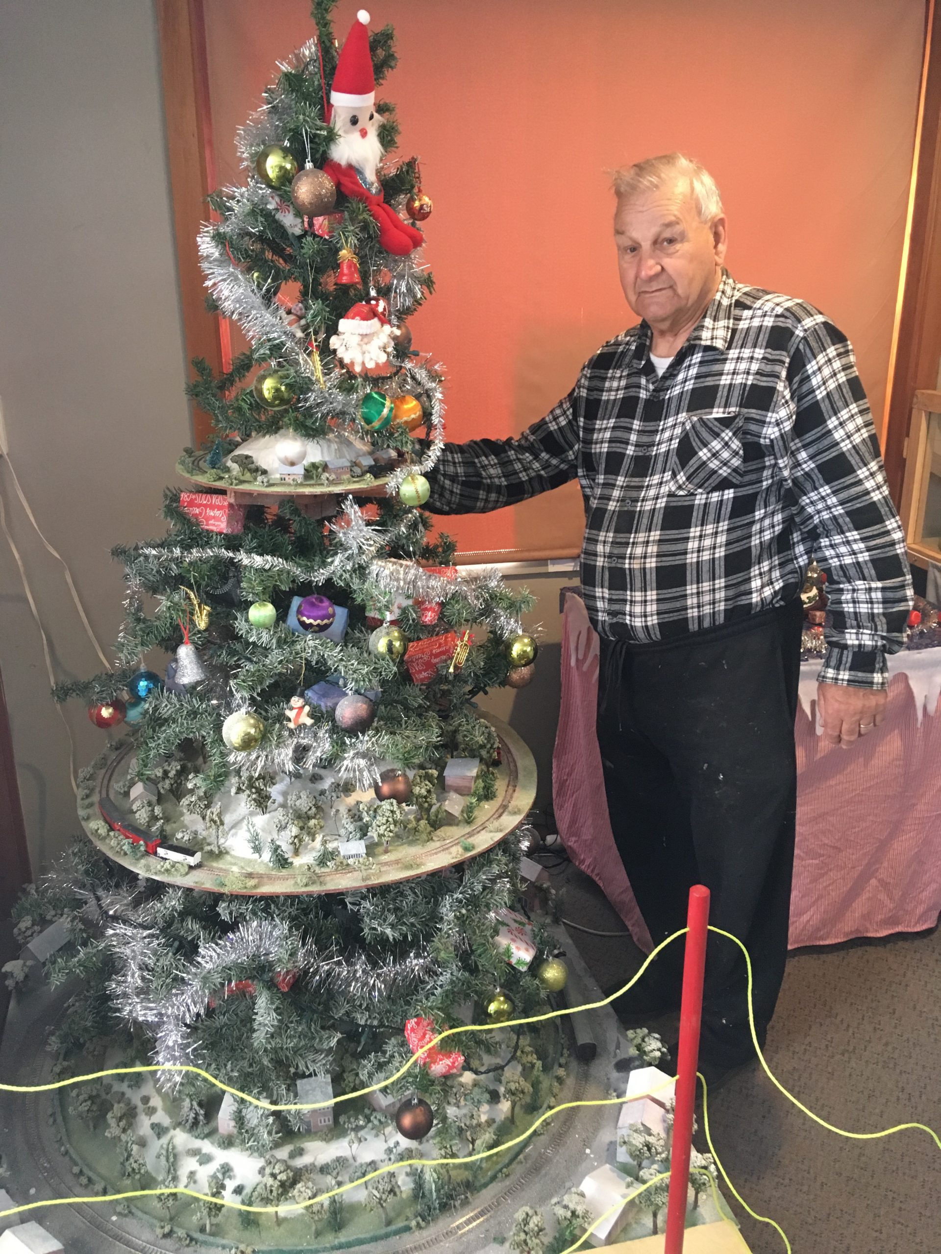 Arthur Linnell puts finishing touches to his train tree at the Thomas Grotto at the club's rooms...