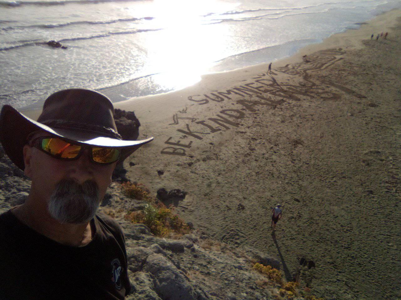 Webb spends hours creating unique murals in the sand; his purpose - just to make people smile....