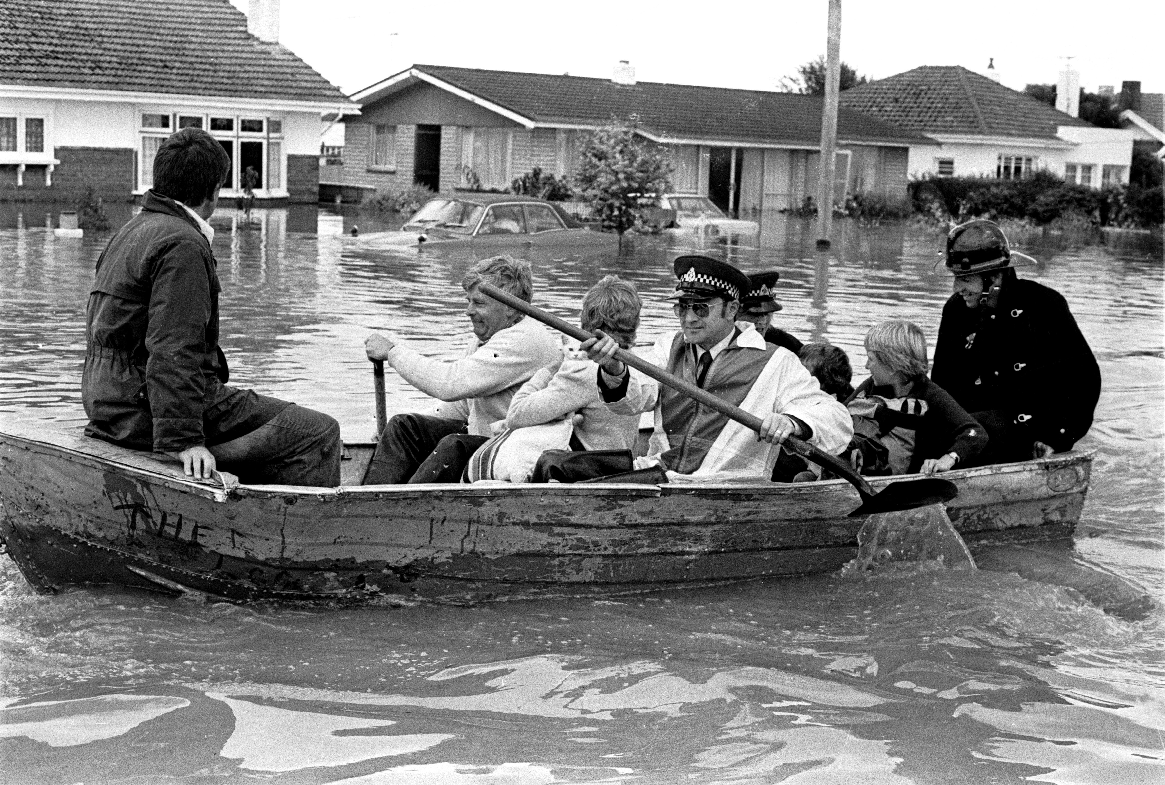 Flood victims being evacuated from Bullar St, Invercargill, on January 27, 1984, include Judith...