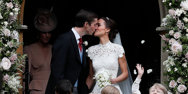 Pippa Middleton and James Matthews kiss after their wedding at St Mark's Church in Englefield,...