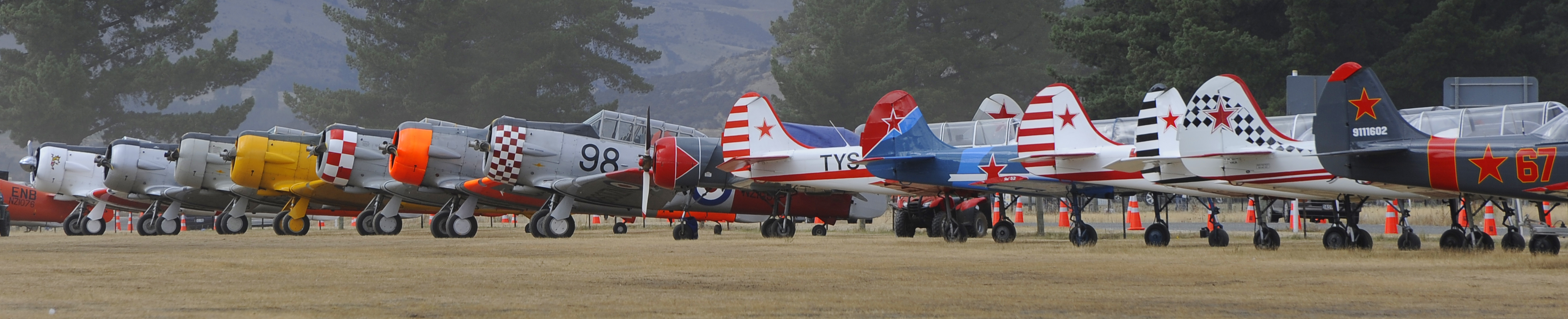 A line up on the Wanaka airshow flightline of T-6 Harvards and Yak-52s.