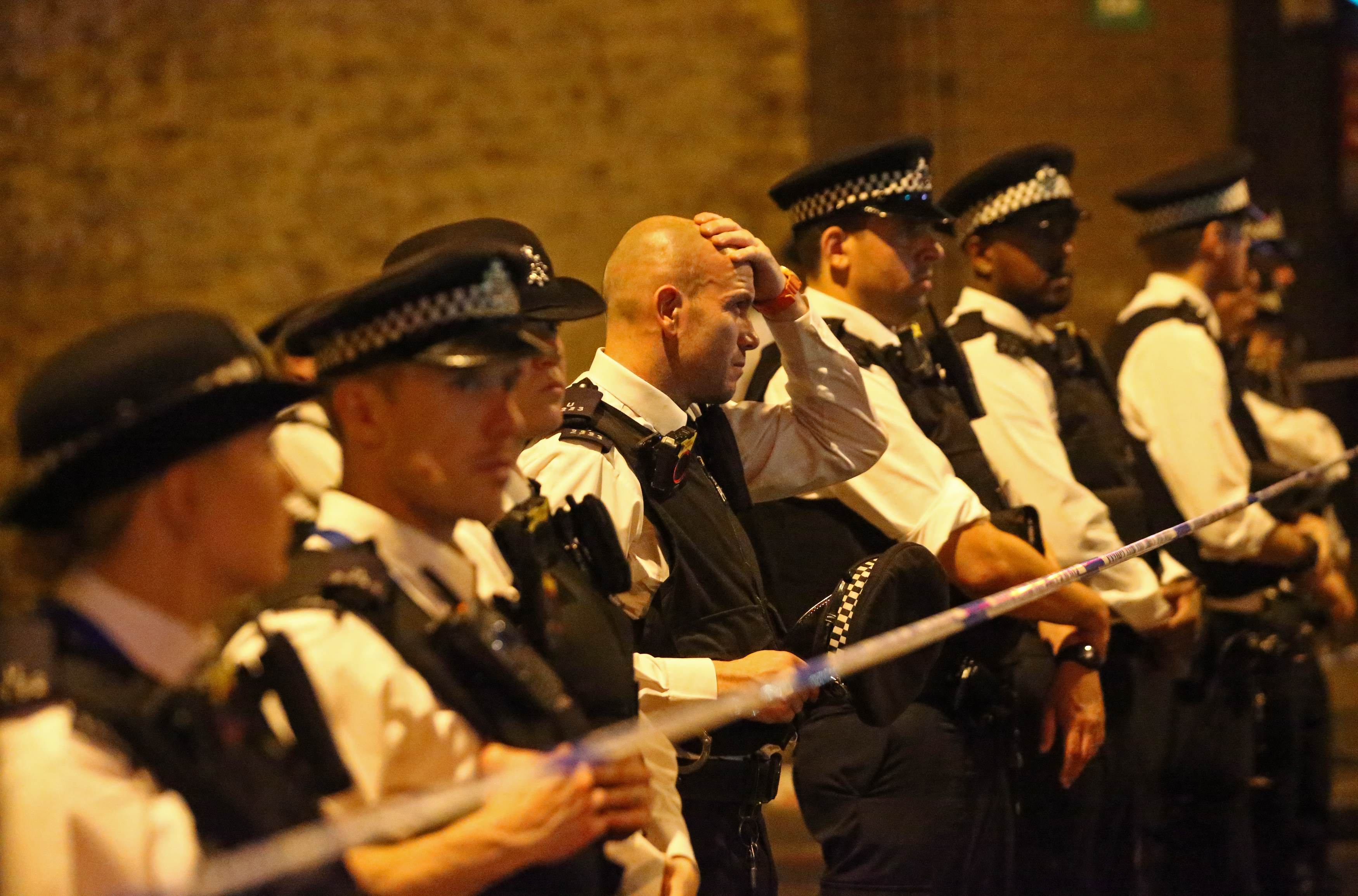 Police officers attend to the scene. Photo: Reuters