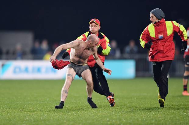A streaker is stopped by security during the round 5 Super Rugby Aotearoa match between the...