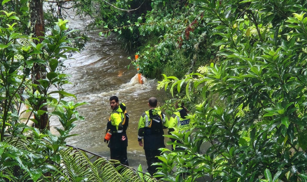 Police inspect a section of Falls Rd near the Mahurangi River where a man and his vehicle was...