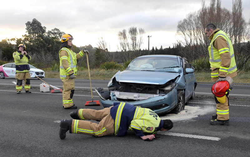 Emergency workers attend the scene of the crash on the Southern Motorway this afternoon. Photo:...