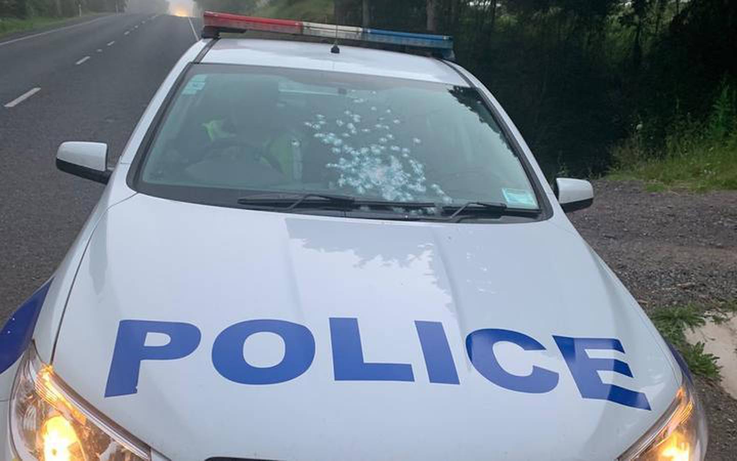 This police car was damaged by an offender who fired shots at the officer driving. Photo: Supplied
