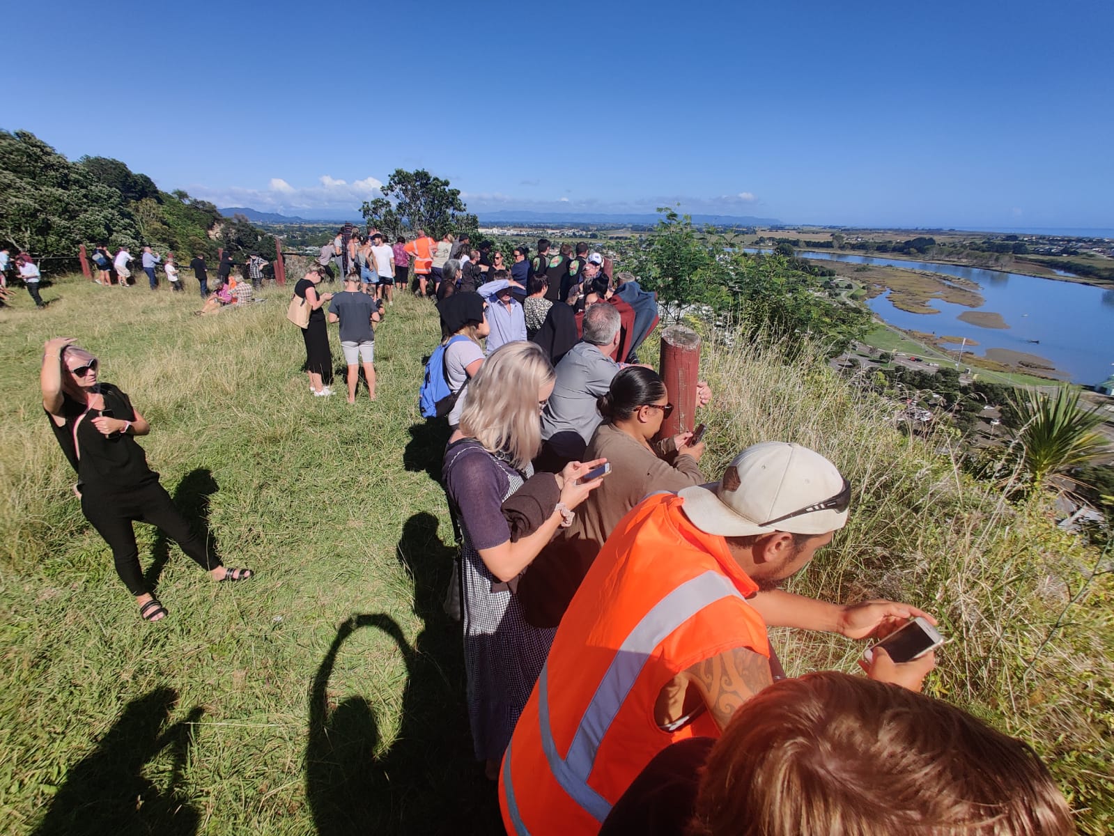 Whakatane residents congregated on high ground earlier today, including at Puketapu Lookout close...