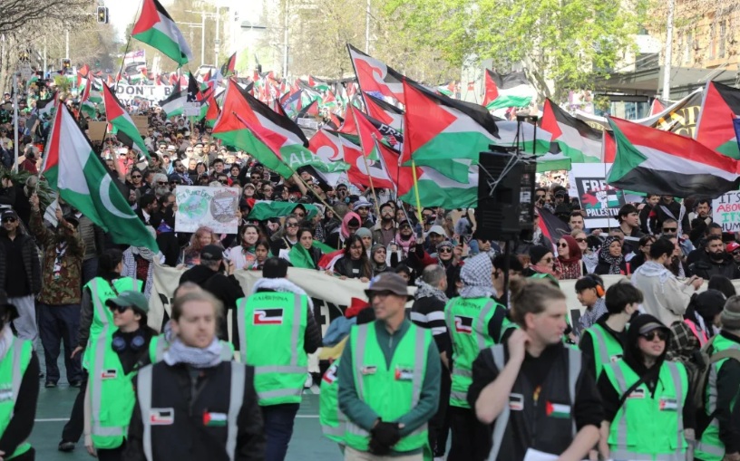 Demonstrators make their way down Queen St in Auckland, demanding the government impose sanctions...