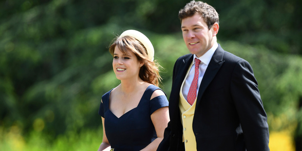 Britain's Princess Eugenie, left and her partner Jack Brooksbank, arrive for the wedding. Photo:...