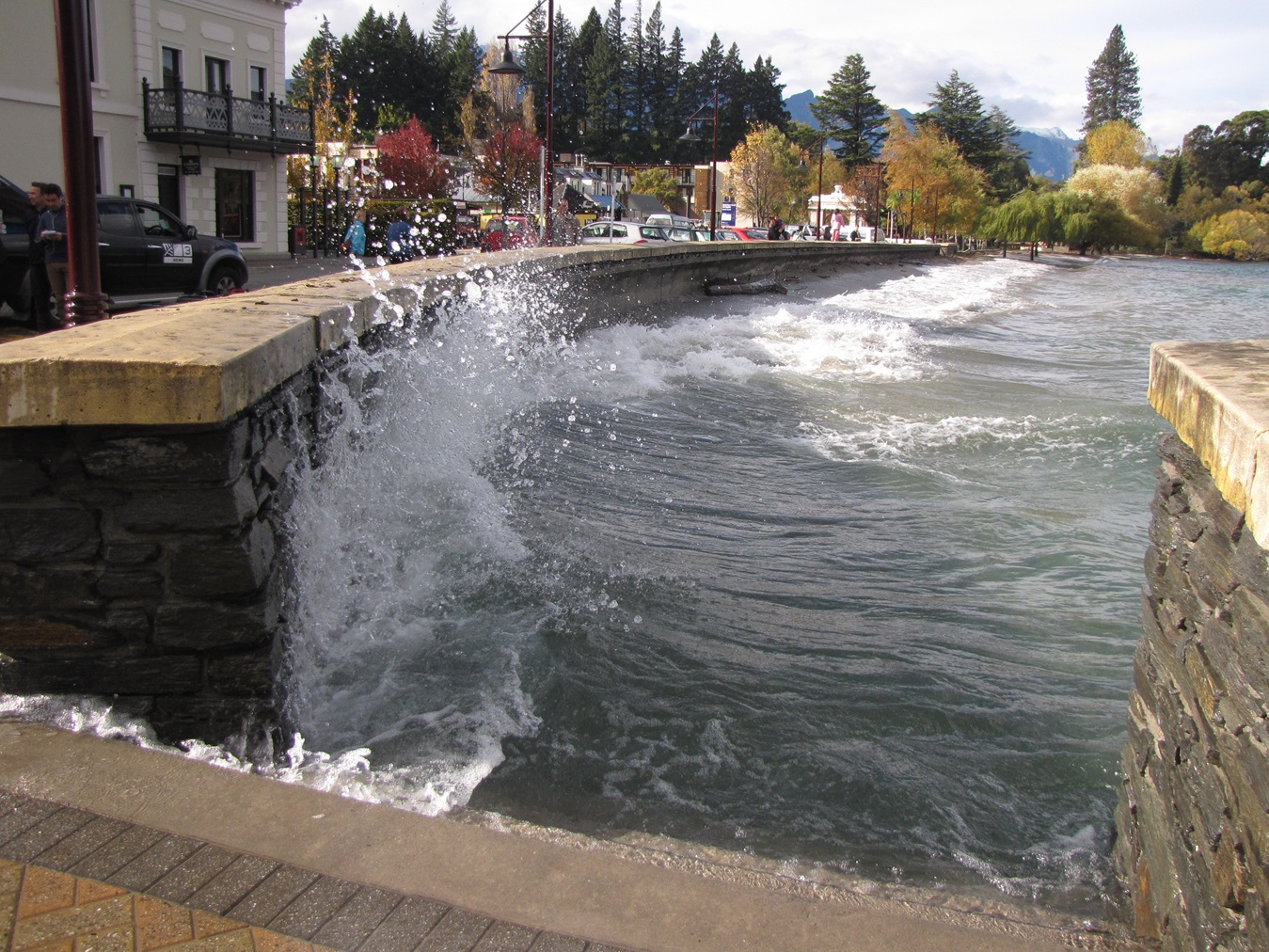 Waves crash against the lake wall in Queenstown Bay after heavy rain. Photo: Joanne Carroll