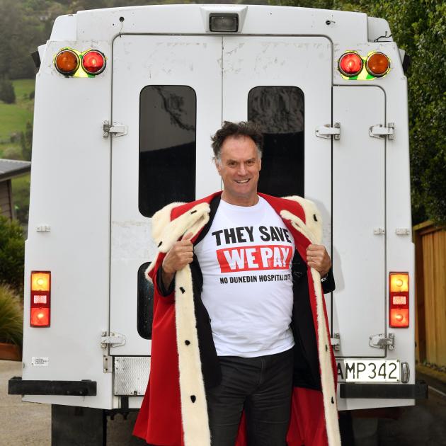 Then mayor Jules Radich in 2024 wearing his "They Save We Pay" campaign T-shirt the city council...