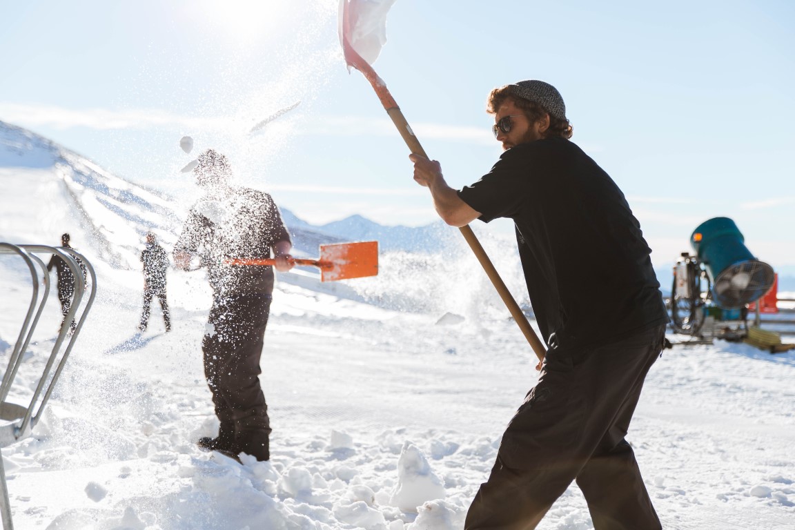 Ski instructors Joe Berrow (front) and Josh Osborne (obscured) hard at work shovelling snow at...