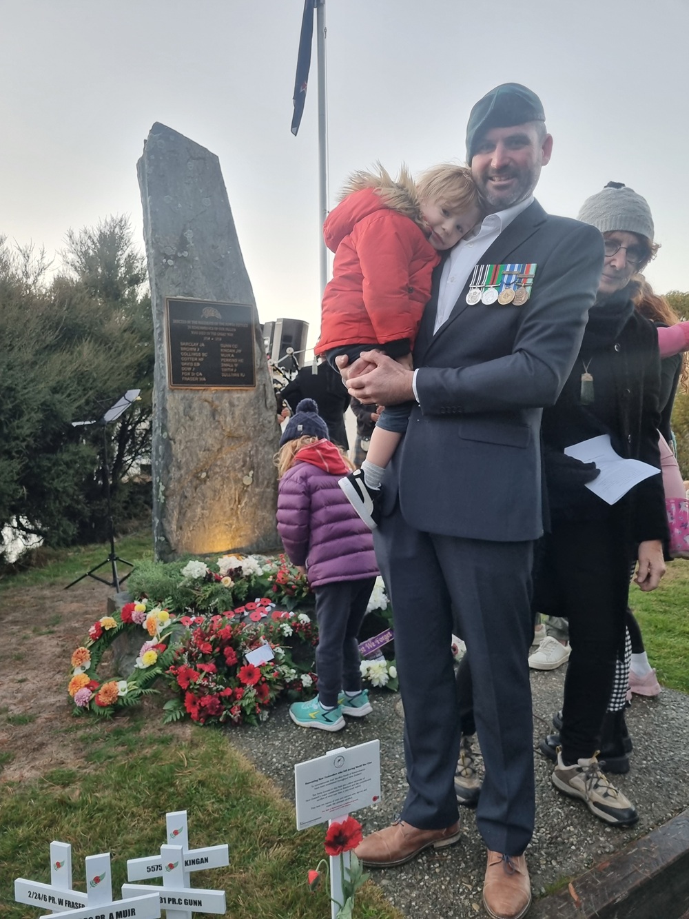 Lance Corporal Dan Leighton with his son Frank at the Lake Hāwea service this morning. Photo:...