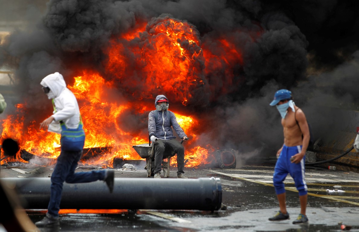 Demonstrators build a fire barricade during a rally against Venezuela's President Nicolas Maduro...