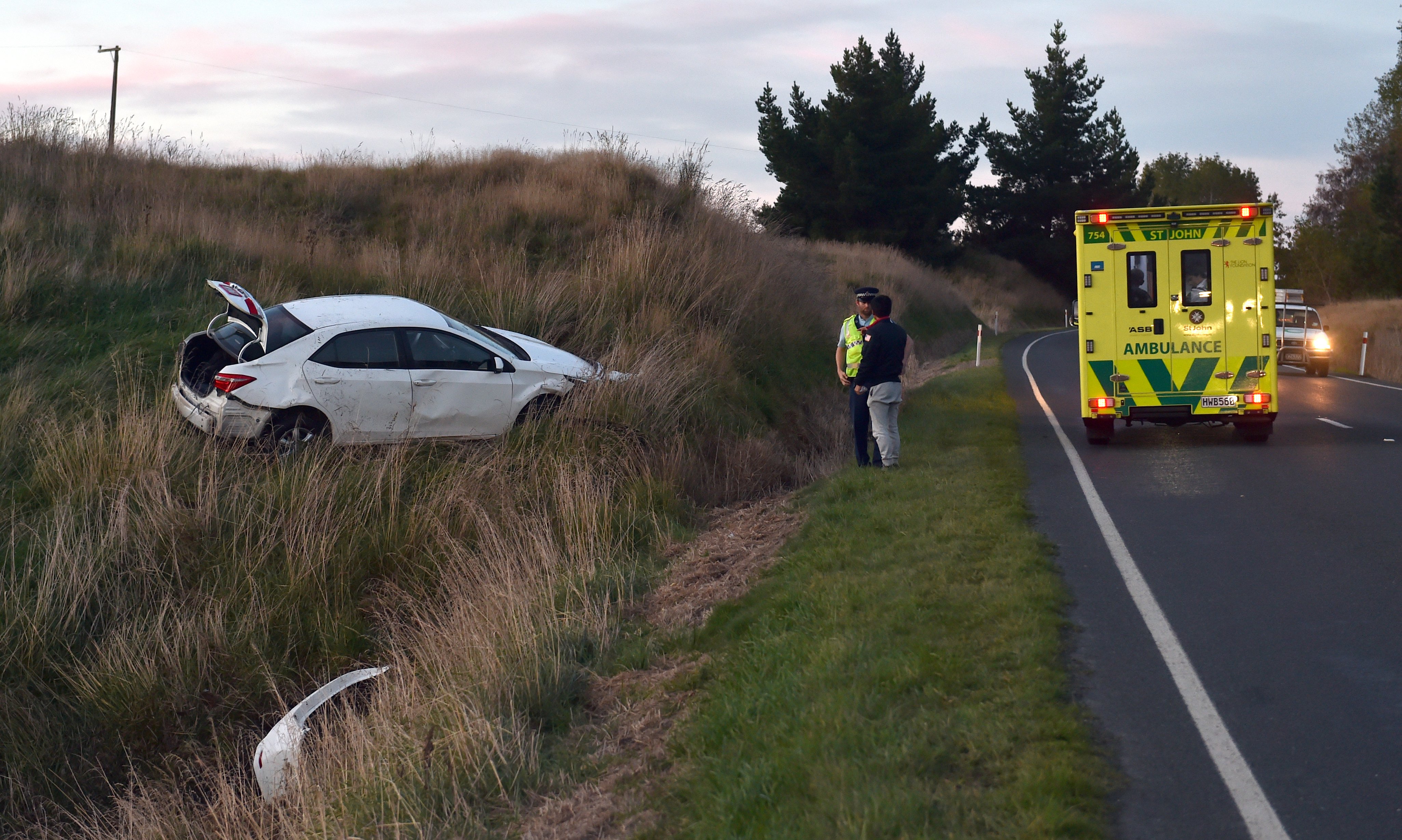 Police and Ambulance at the scene of a car accident North of Waihola on Tuesday. PHOTO PETER MCINTOSH