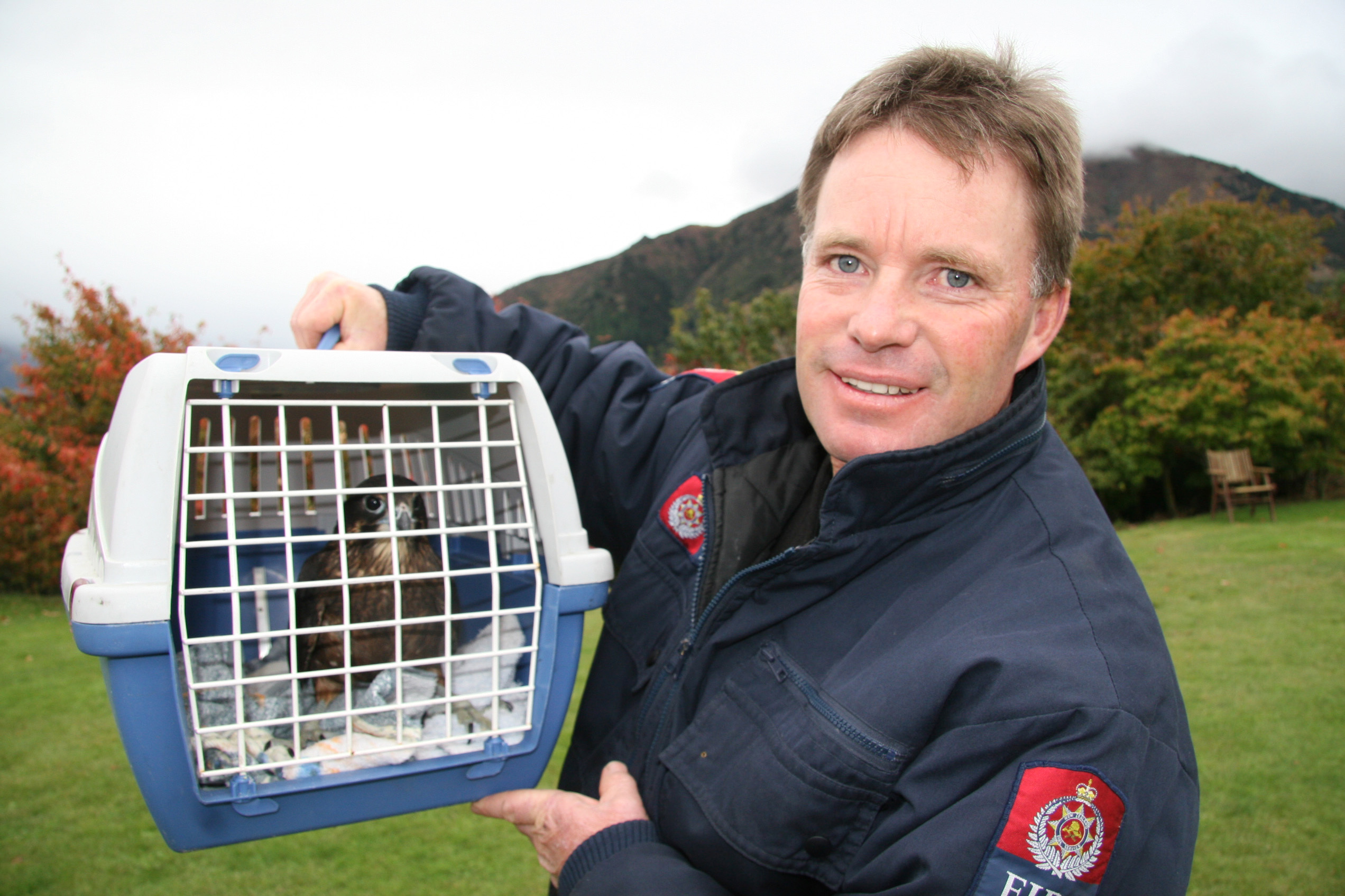 Builder and Lake Hawea Volunteer Fire Brigade Chief Fire Officer Brent Arthur holds a karearea ...