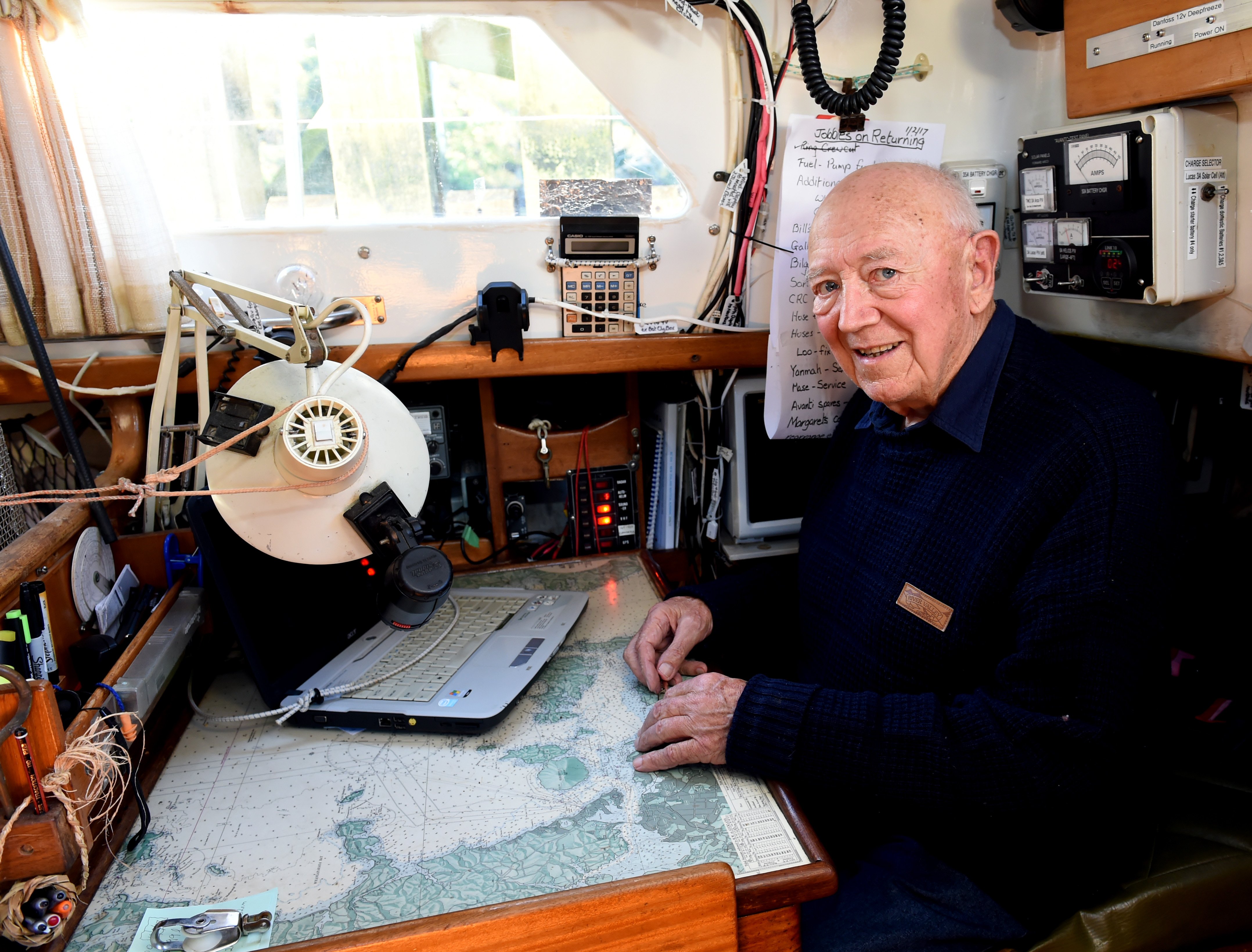 Bill at the chart table in the aft of the yacht’s saloon. PHOTO: GREGOR RICHARDSON