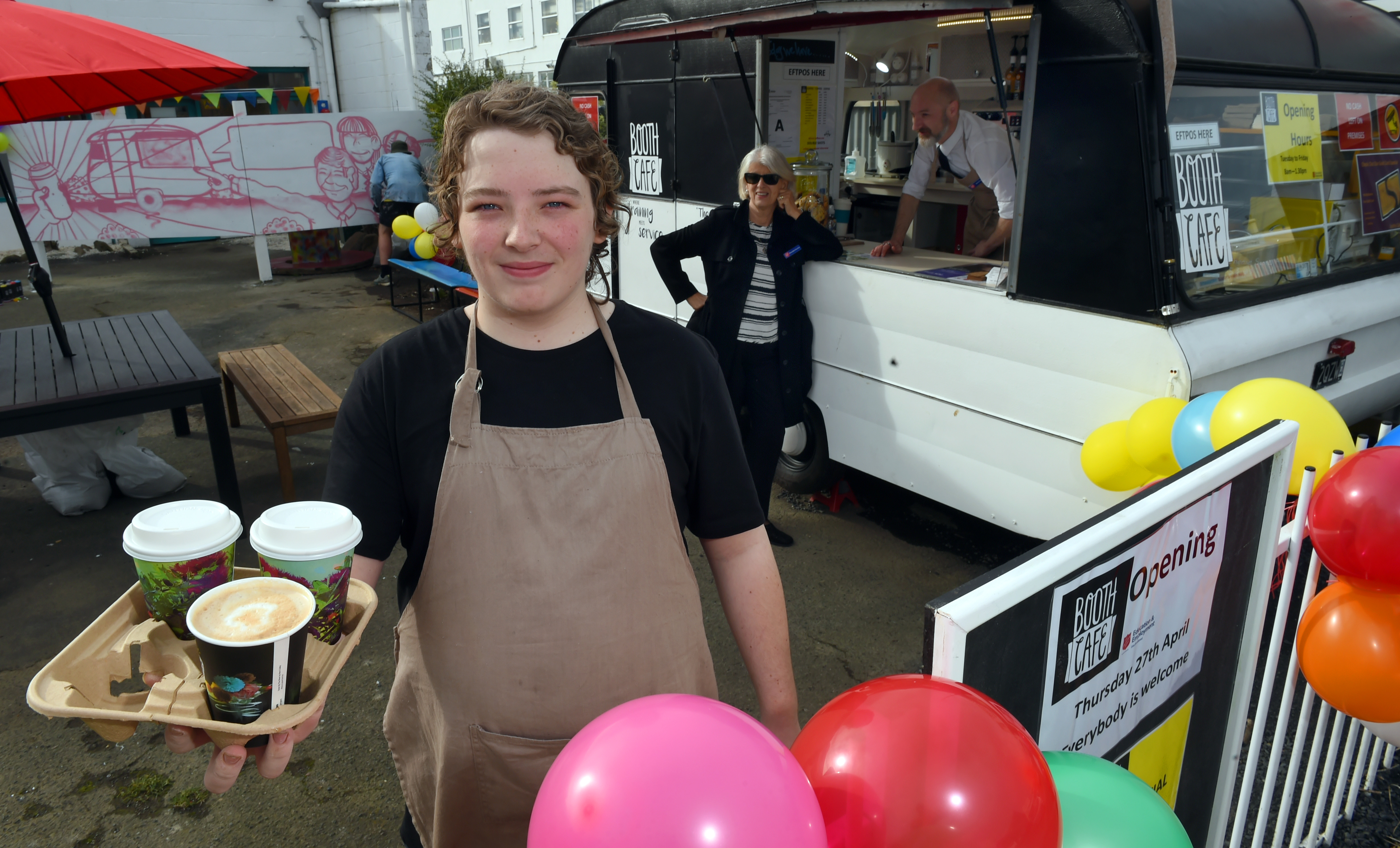 Salvation Army alternative education student Wayde Fryer (15) serves coffee, watched by education...