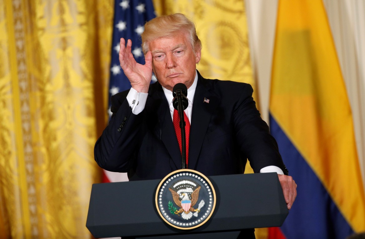 Donald Trump listens to a question during a joint news conference with Colombia's President Juan...