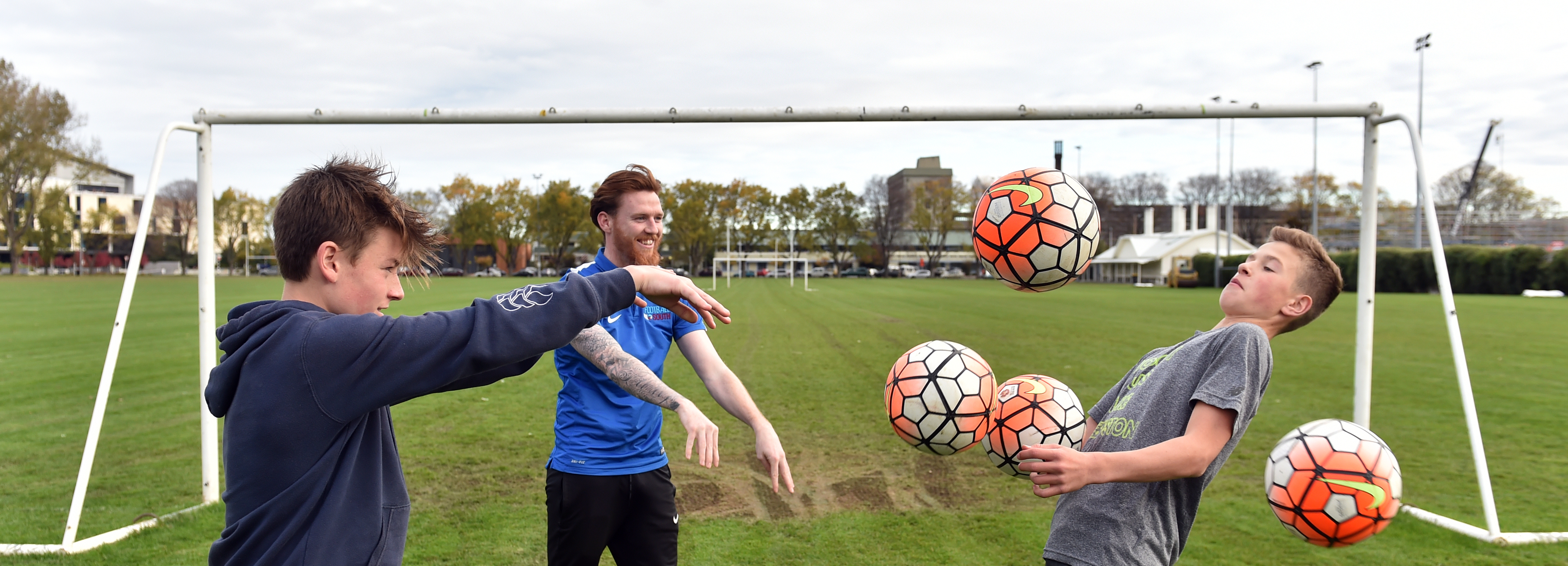 Footballers Oliver Colloty (13, left) and Joseph La Hood (13) with coach Danny Ledwith at the...