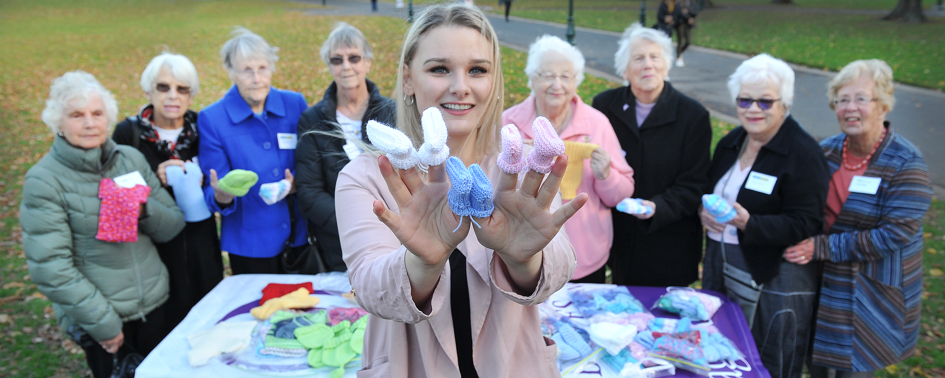 Otago Polytechnic first year midwifery student Tyla-Jaide Jones with some of the knitted clothing...