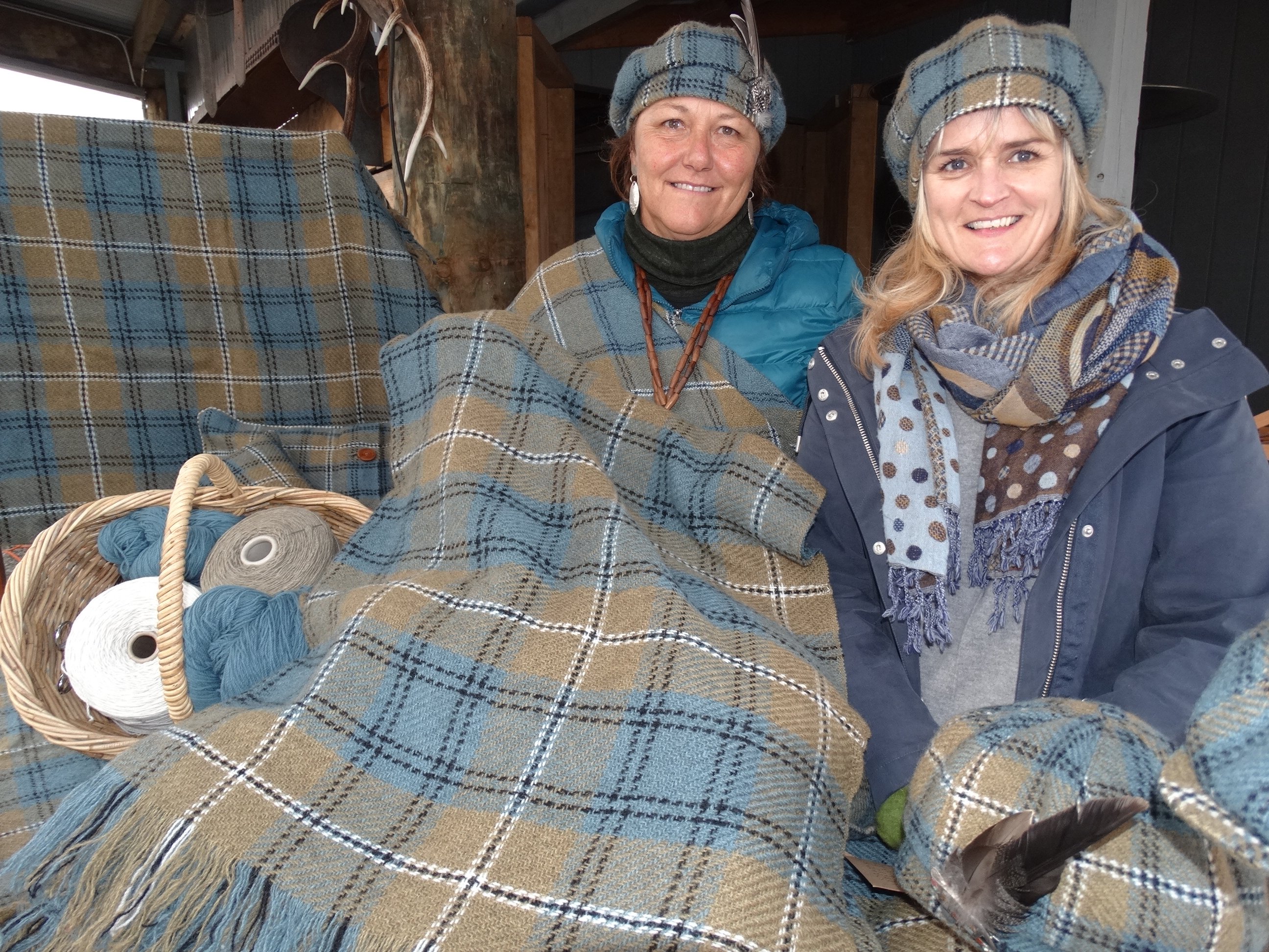 The Southern Lakes tartan was unveiled at the Great Glenorchy Getaway Day by the creator's daughter, Hilary Johnstone (left) at Mrs Woolly's General Store. Also rugged up is Debbie Crompton, the store's general manager. Photo: Louise Scott.