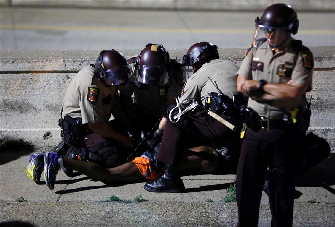 Police make an arrest during the demonstration. Photo Reuters