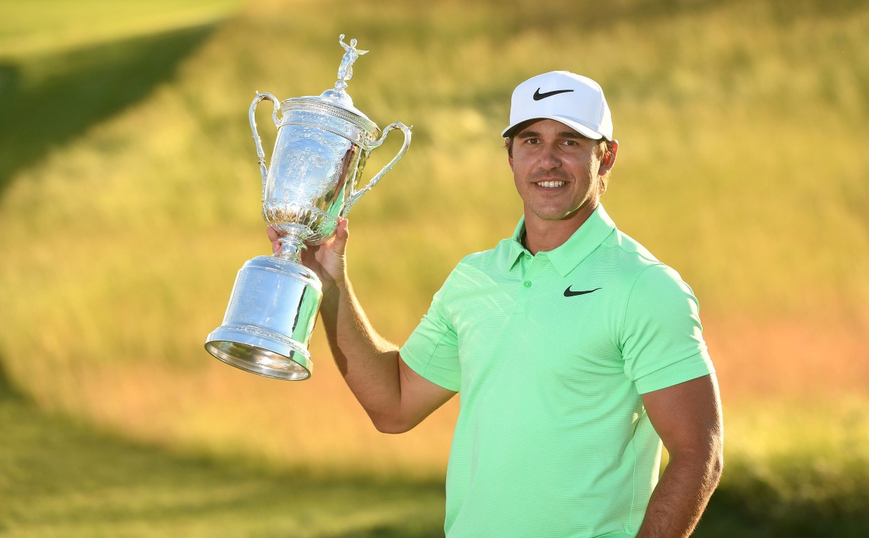 Brooks Koepka poses with the trophy after winning the US Open at Erin Hills. Photo: Rob...