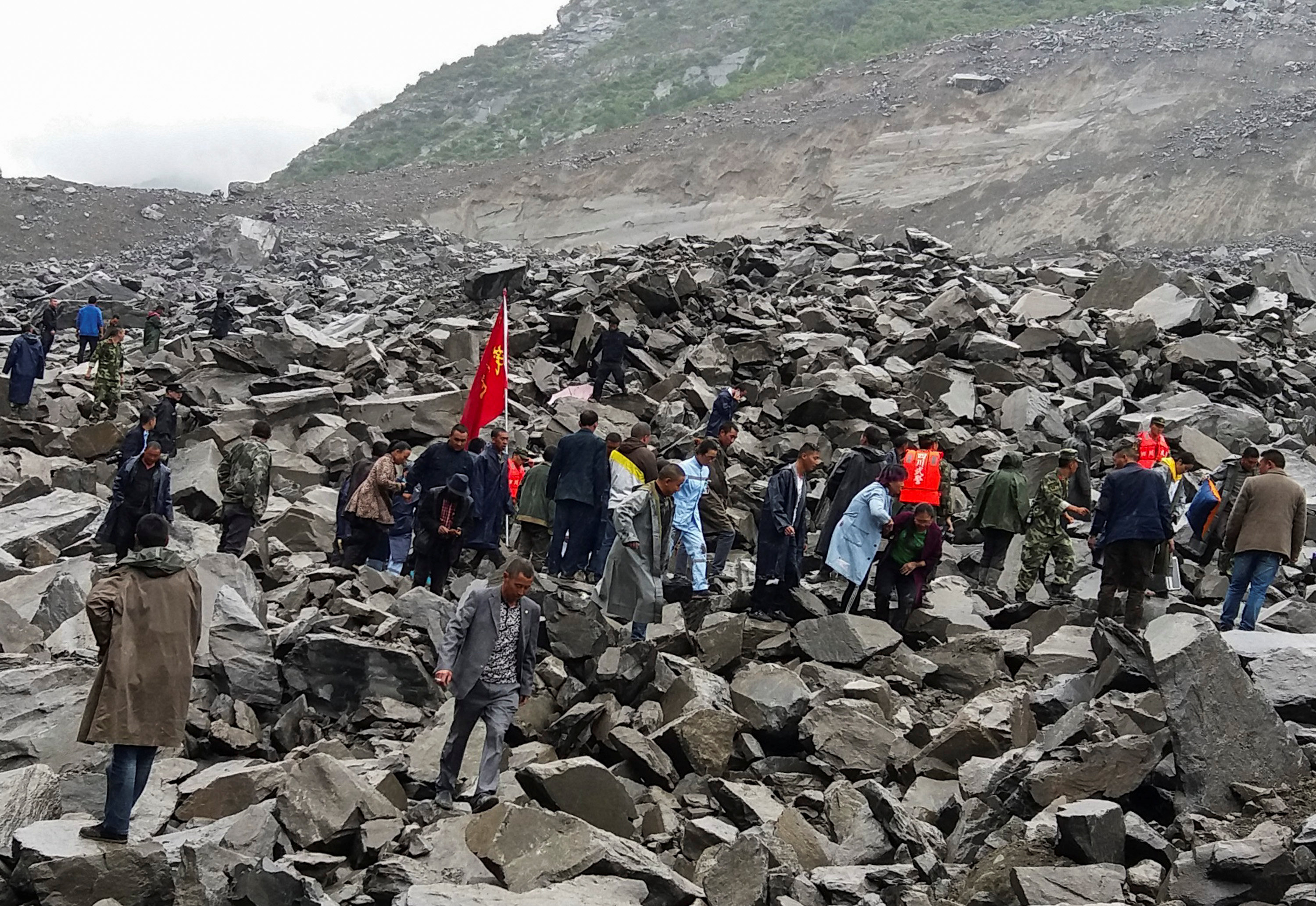 15 bodies found after landslide buries scores in China