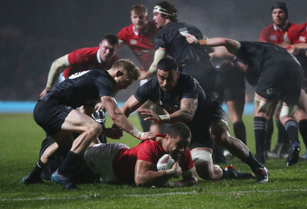 Taulupe Faletau of the Lions is hauled down short of the try line. Photo: Getty