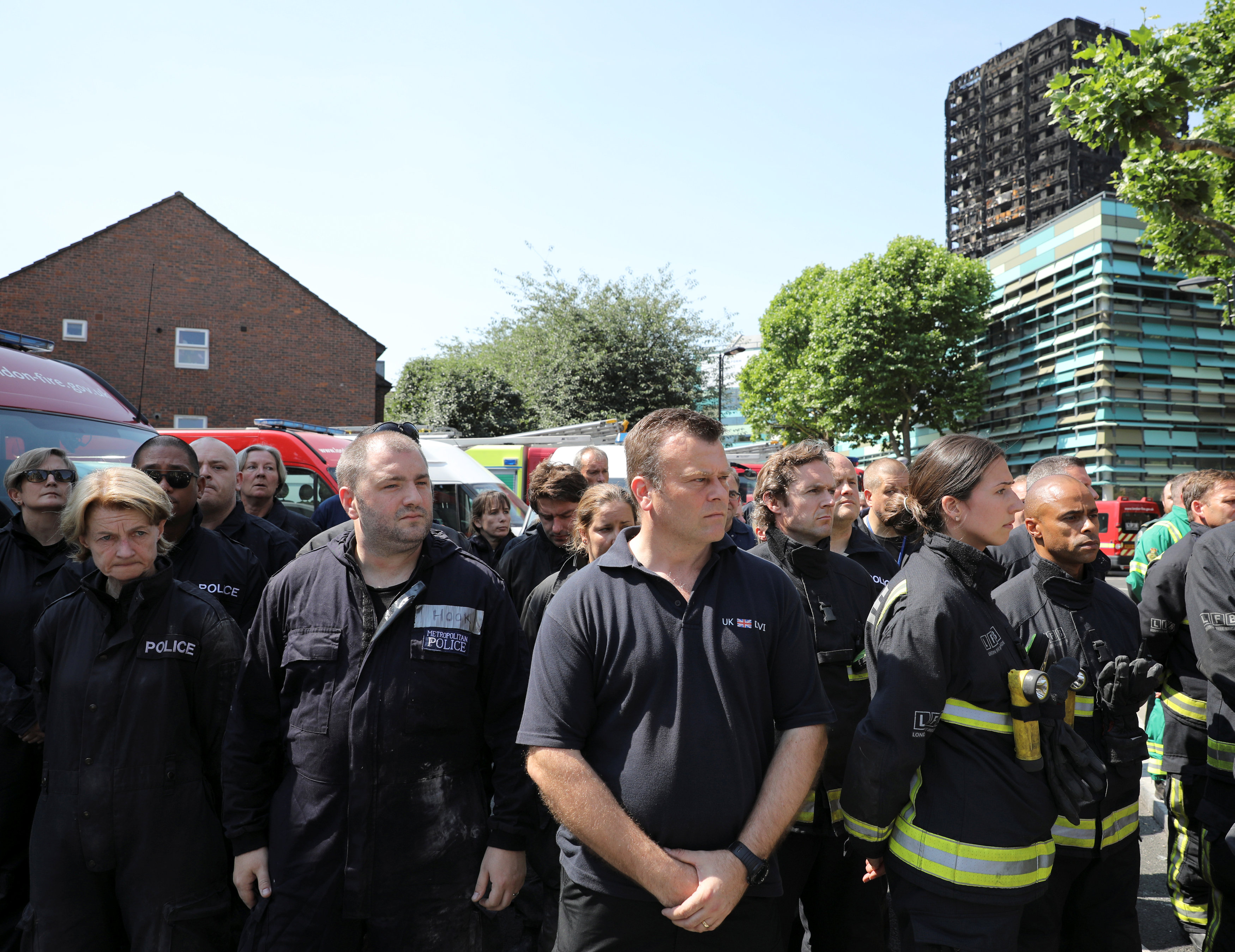 Emergency services members observed a minutes silence for the victims of the fire. Photo: Reuters