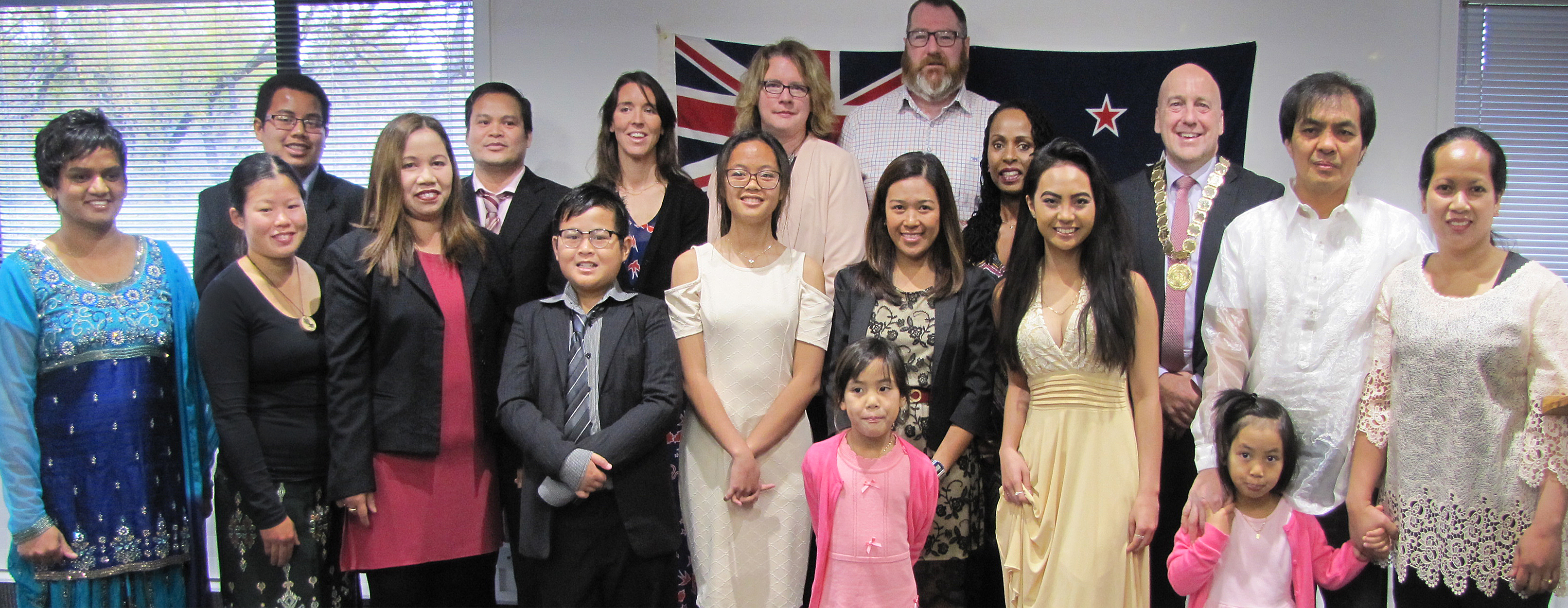 Central Otago Mayor Tim Cadogan poses with the region’s newest New Zealand citizens after a...