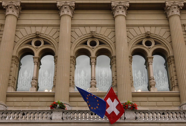 The flags of the European Union and Switzerland flutter in the wind at the Swiss Parliament...