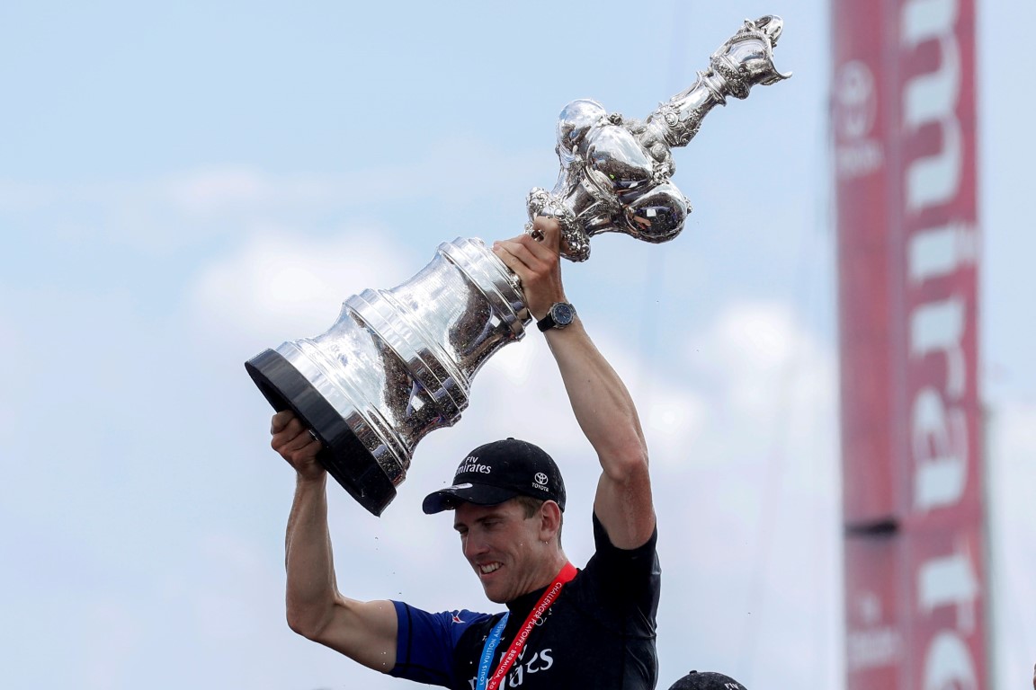 Peter Burling holds up the trophy after Team New Zealand's win over Oracle Team USA. Photo Reuters