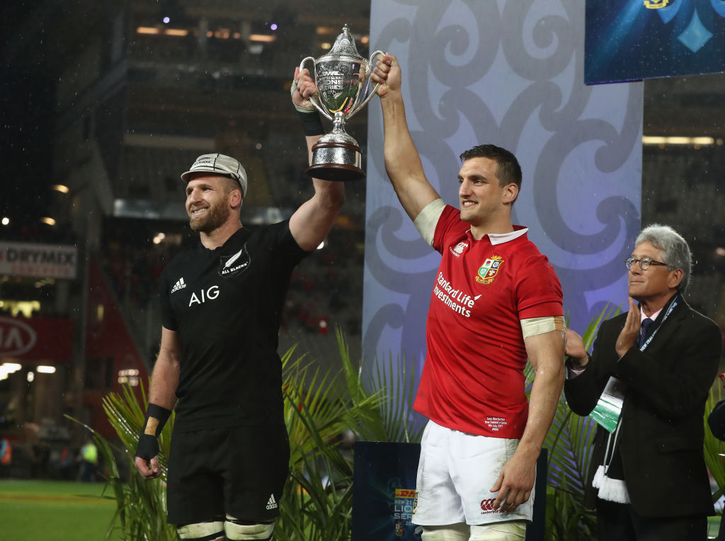 Sam Warburton, (R) the Lions captain, lifts the trophy with Kieran Read, the All Black captain...