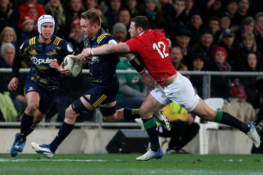 Gareth Evans slips through the tackle of Robbie Henshaw of the Lions during the Highlanders vs...