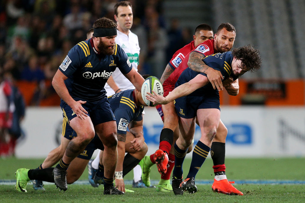 Richard Buckman (R) of the offloads the ball to team mate Liam Coltman of the Highlanders. Photo:...