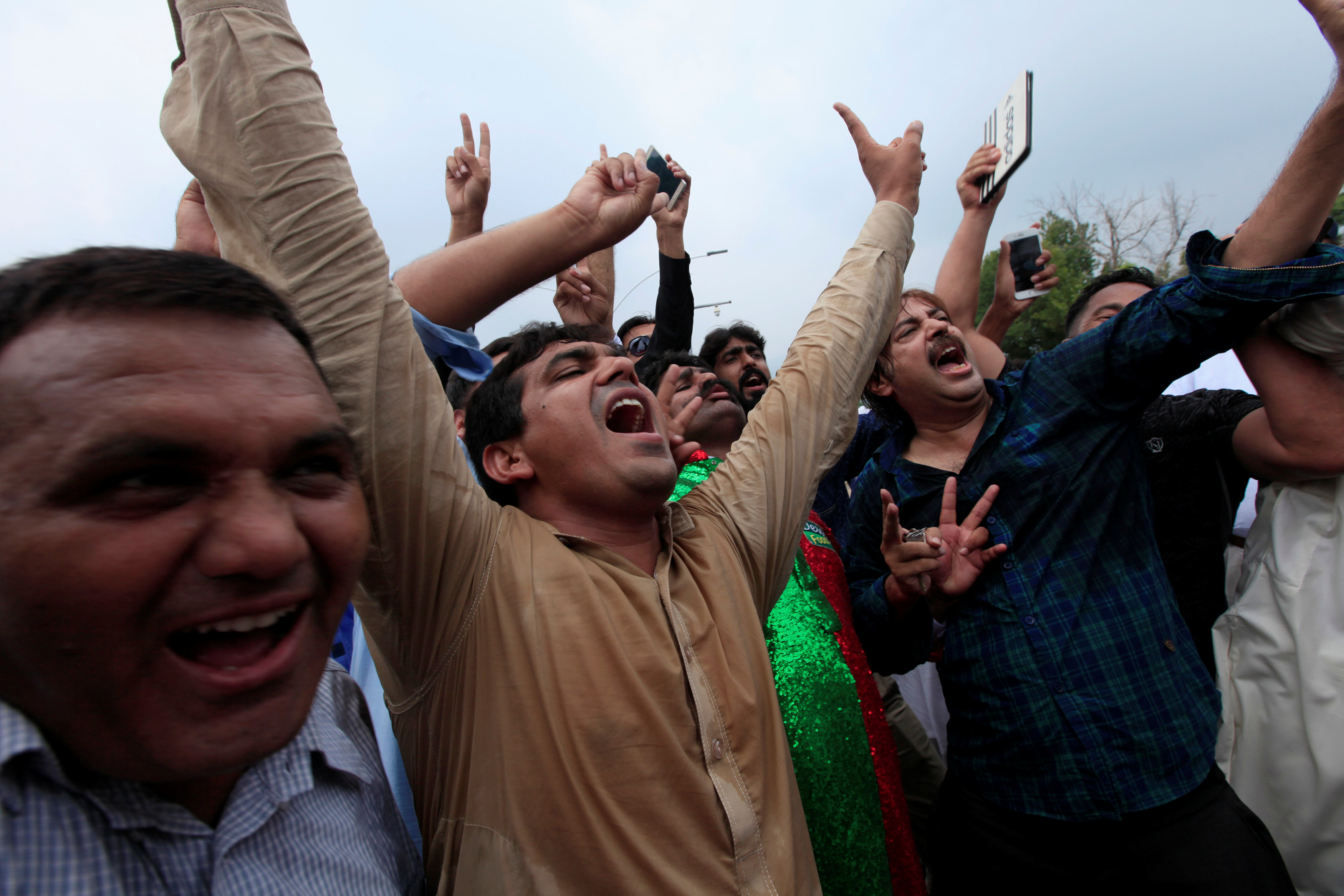 Opponents of Pakistan's Prime Minister Nawaz Sharif shout slogans after the Supreme Court's...