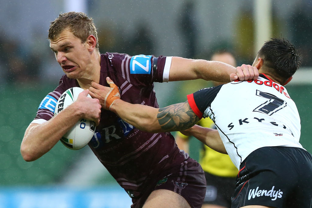 Tom Trbojevic of the Sea Eagles looks to break from a tackle by Shaun Johnson of the Warriors....