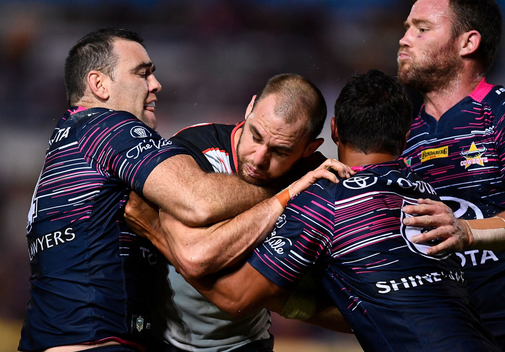 Simon Mannering of the Warriors is tackled by Te Maire Martin and Kane Linnett of the Cowboys....