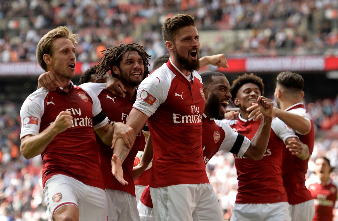 Arsenal's Olivier Giroud celebrates with teammates after scoring the winning penalty. Photo...