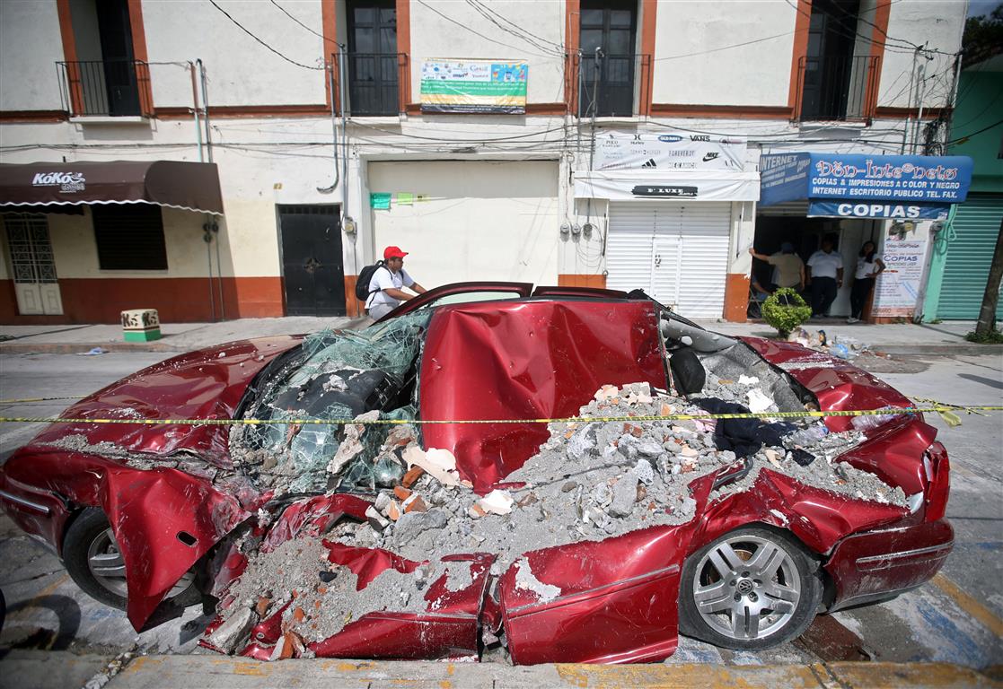 A car covered in rubble after the quake, in Jojutla de Juarez.