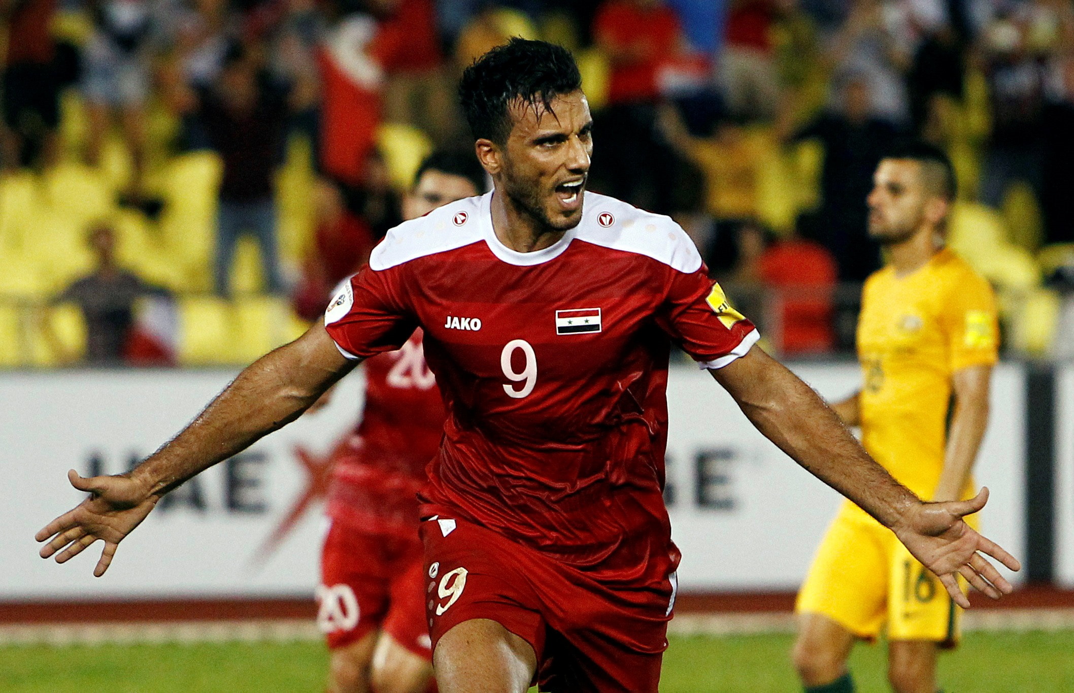 Omar Al Somah celebrates his late equalising penalty for Syria against Australia. Photo: Reuters
