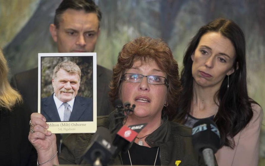 Anna Osborne holds aloft a photograph of her husband Milton, who perished in the Pike River Mine...