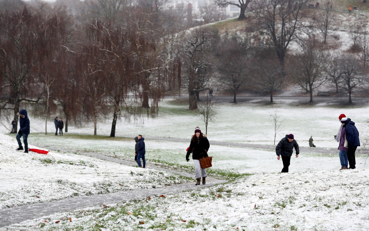 People walk through the snow in Greenwich Park, London. Photo Reuters
