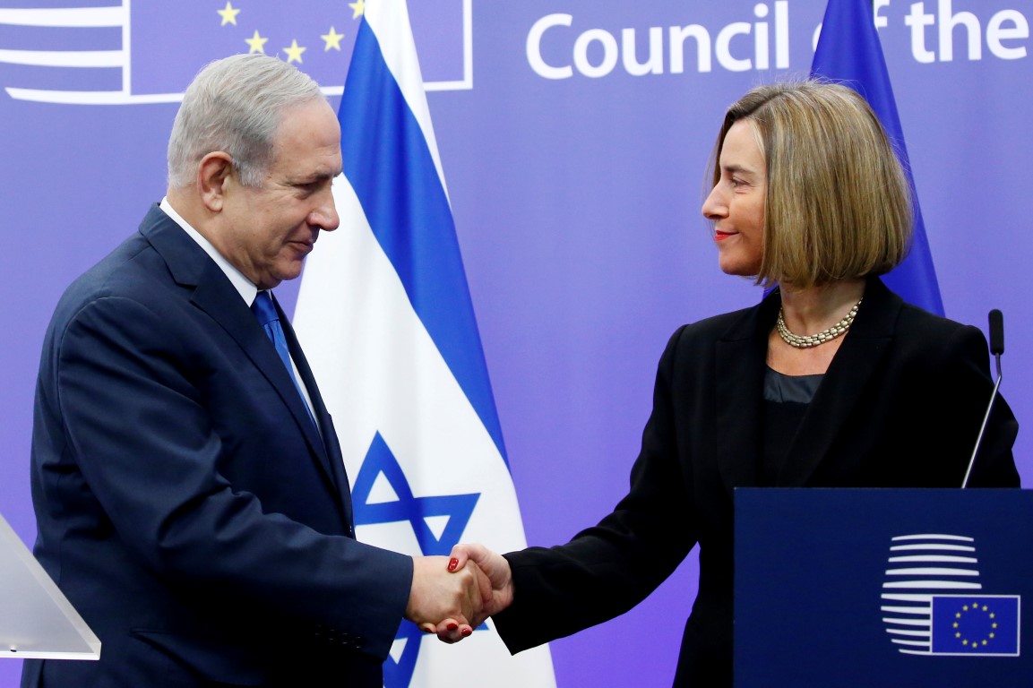 Israeli Prime Minister Benjamin Netanyahu shakes hands with EU foreign policy chief Federica...