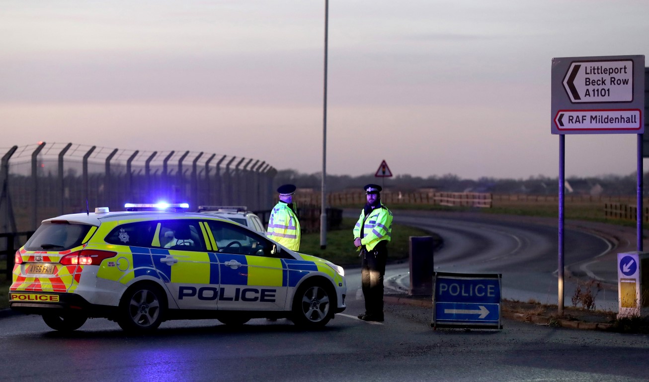 Police stand guard at the entrance to the US Air Force base at RAF Mildenhall after the incident....