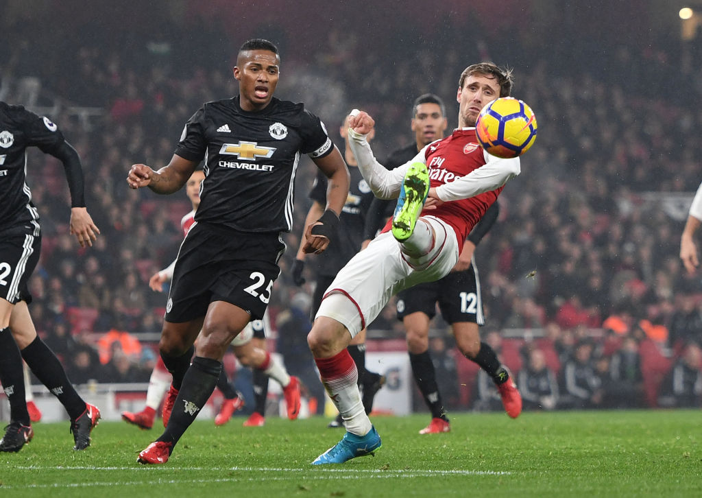 Arsenal's Nacho Monreal tries to control the ball under pressure from Manchester United's Antonio...