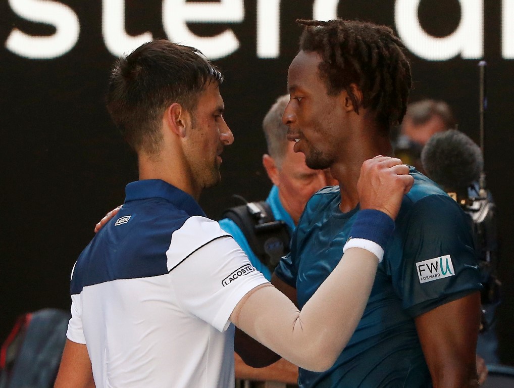 Novak Djokovic (L) and Gael Monfils embrace after their match. Photo: Reuters 
