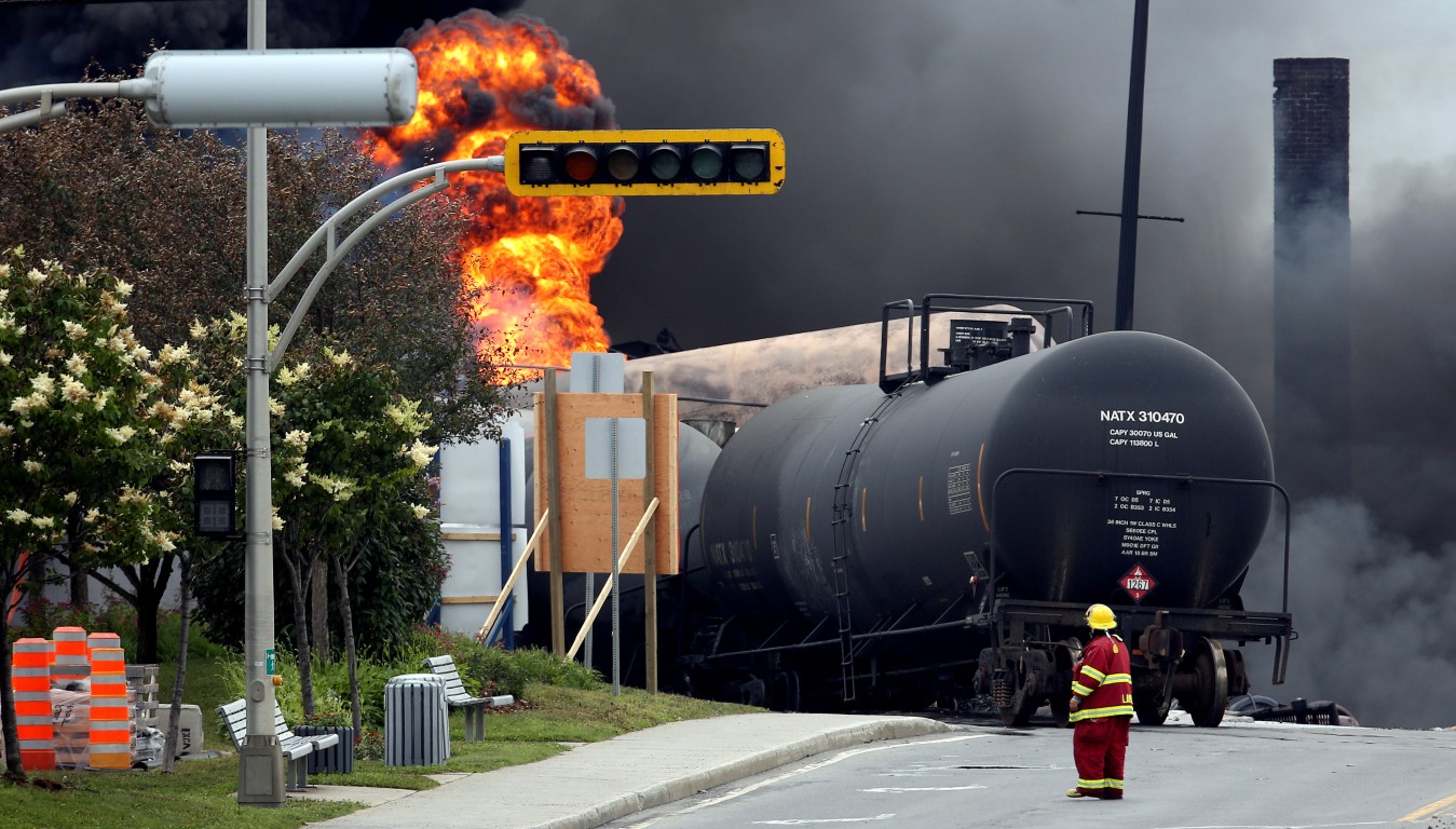A firefighter walks past a burning wagon at the scene of the accident in July 2013. Photo: Reuters